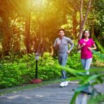indian-asian-young-couple-jogging-running-exercising-stretching-outdoors-park-nature